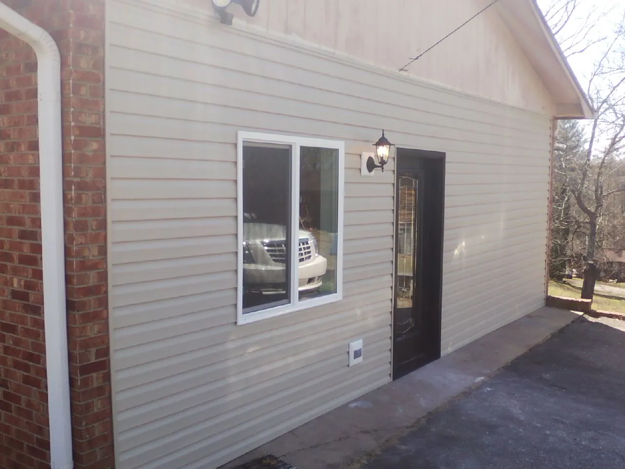 New vinyl siding and entry door on a room addition in Beaver